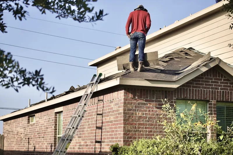 Professional roofer working on a residential roof in Walmo